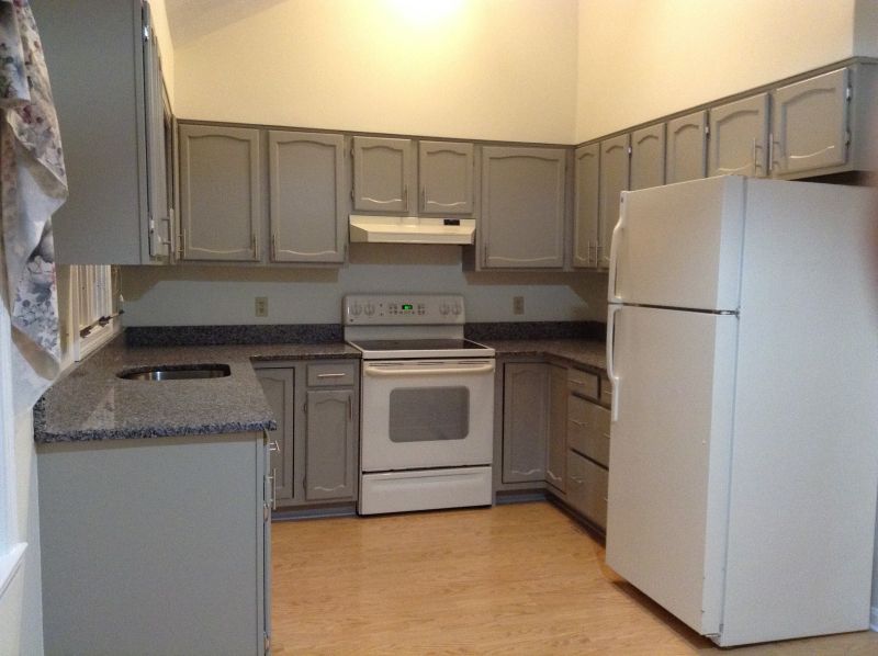 Freshly painted gray kitchen cabinets with nickel hardware in a Shrewsbury, MA condo (featured image size)